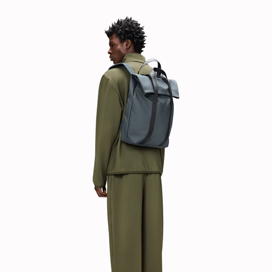 The Rains 2 Way Tote Backpack is characterised by a fold-top opening with the addition signature TPU strap details with top handles.