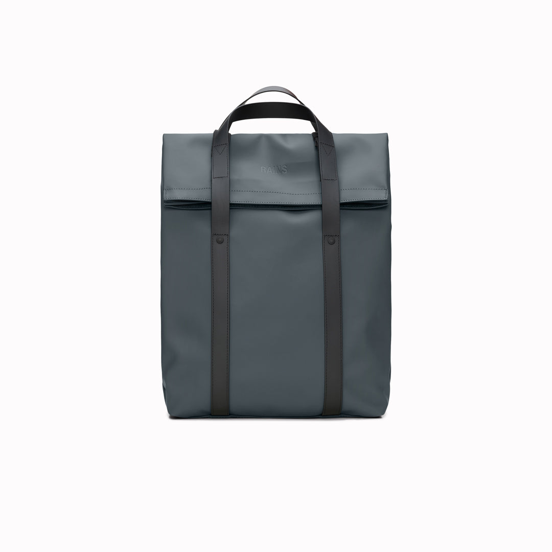 The Rains 2 Way Tote Backpack is characterised by a fold-top opening with the addition signature TPU strap details with top handles.