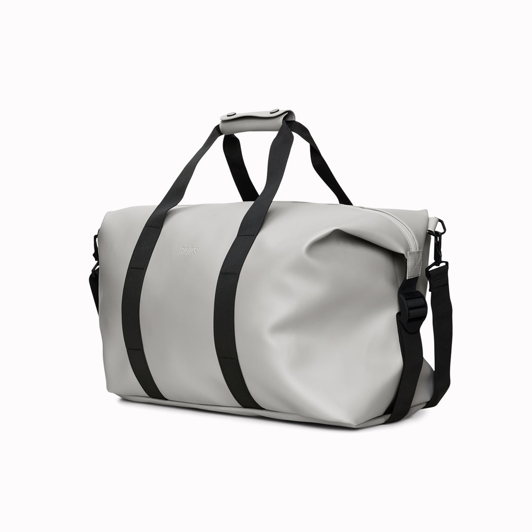 The Hilo Weekend Bag by Rains is a great contemporary gym or overnight bag. It features a single main compartment, carry handles, a detachable shoulder strap, and adjustable lock slider buckles on the sides.