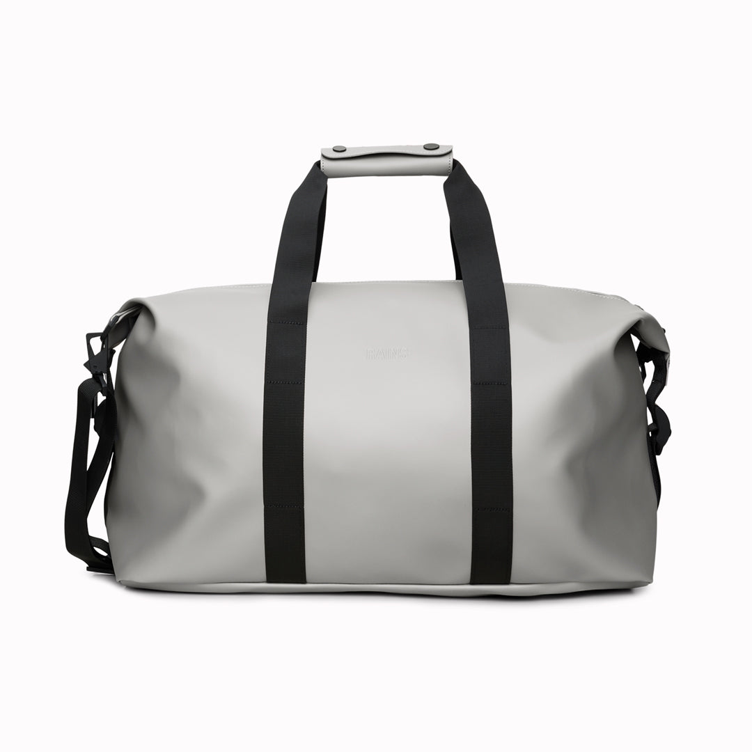 The Hilo Weekend Bag by Rains is a great contemporary gym or overnight bag. It features a single main compartment, carry handles, a detachable shoulder strap, and adjustable lock slider buckles on the sides.
