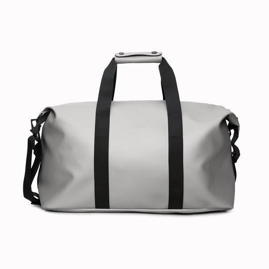 The Hilo Weekend Bag by Rains is a great contemporary gym or overnight bag. It features a single main compartment, carry handles, a detachable shoulder strap, and adjustable lock slider buckles on the sides.