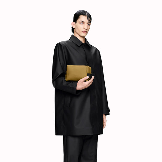 As-Worn - SS26 Wash Bags by Rains in their new season Dawn colourway. A cube shaped wash bag with one main compartment with inside sleeve pockets and is large enough to fit one’s essential toiletries.