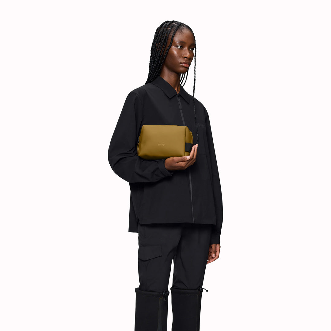 As-Worn - SS26 Wash Bags by Rains in their new season Dawn colourway. A cube shaped wash bag with one main compartment with inside sleeve pockets and is large enough to fit one’s essential toiletries.