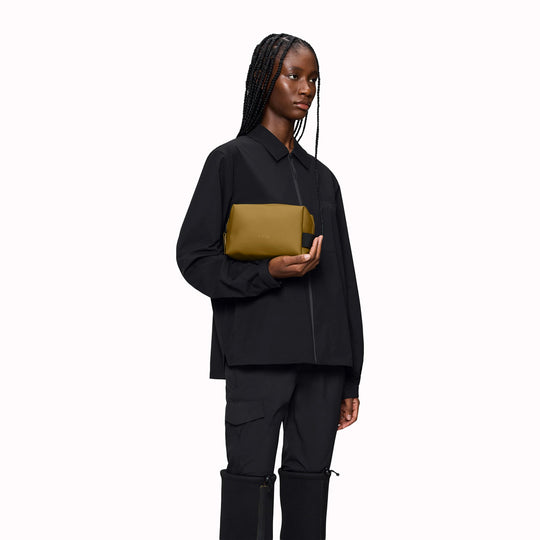 As-Worn - SS26 Wash Bags by Rains in their new season Dawn colourway. A cube shaped wash bag with one main compartment with inside sleeve pockets and is large enough to fit one’s essential toiletries.