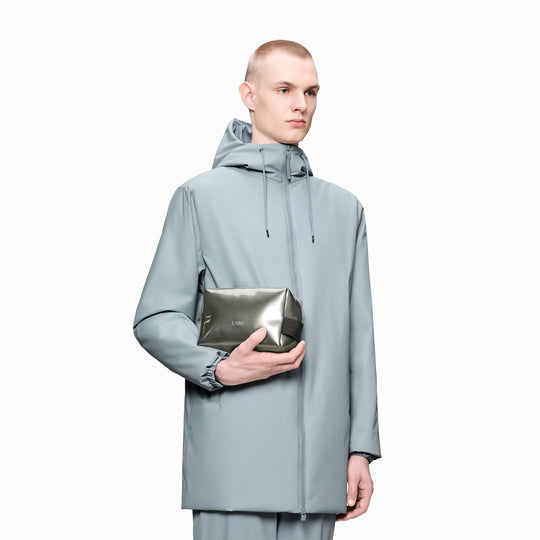 SS26 Wash Bags by Rains in their new season metallic silver Raven colour. A cube shaped wash bag with one main compartment with inside sleeve pockets and is large enough to fit one’s essential toiletries. 