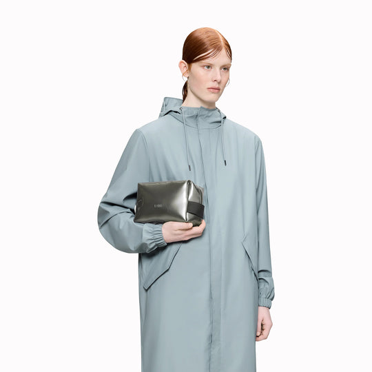 SS26 Wash Bags by Rains in their new season metallic silver Raven colour. A cube shaped wash bag with one main compartment with inside sleeve pockets and is large enough to fit one’s essential toiletries. 