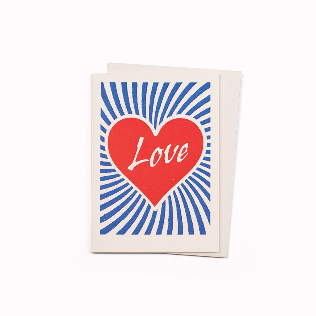 Mini greeting card designed and published by Archivist. 2 colour letterpress printed of a red heart with Love inside it.