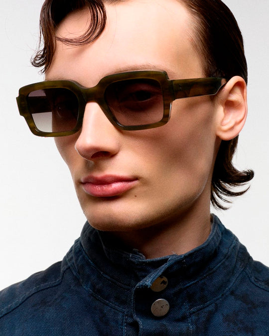 The sharp rectangular frames are crafted by hand from organic and biodegradable acetate, from&nbsp;Mazzucchelli while stainless steel hinges and coated screws ensure premium quality for lifelong wear.&nbsp;