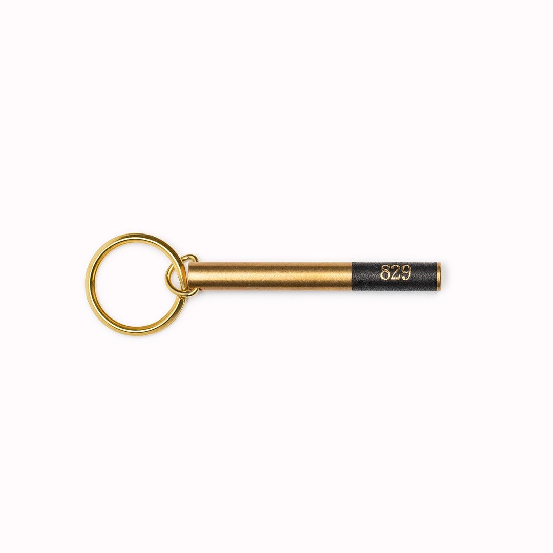 Brass cylindrical keyring from Japanese brand Picus. These small but weighty keychains have been designed to resemble upmarket hotel key fobs and are made from solid brass with a black leather decorative end.