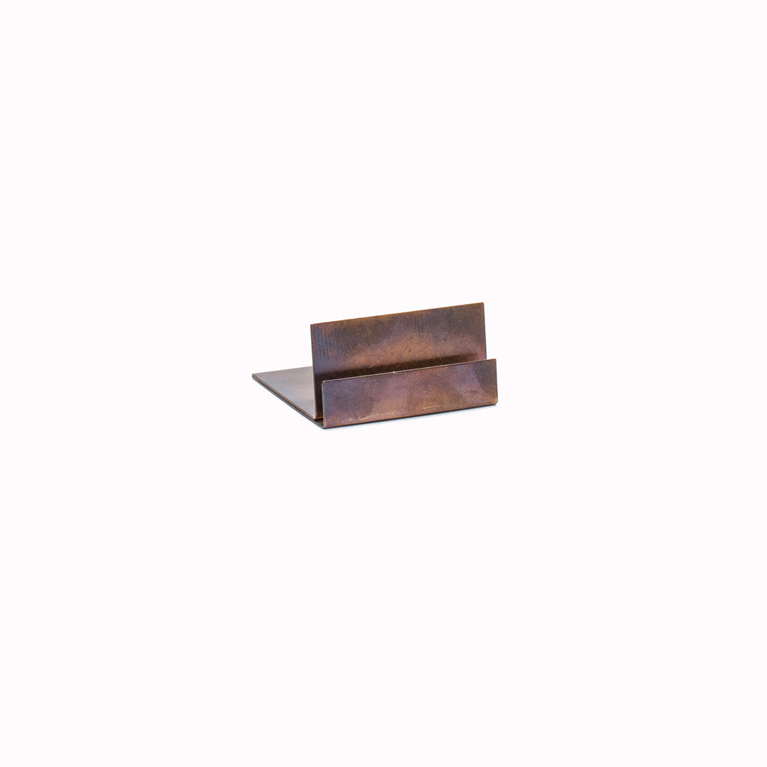 Postcard Stand has a slot depth of 40mm and is made of aged brass. It is expertly crafted in Japan and will develop a natural patina over time. Please avoid cleaning with chemicals.