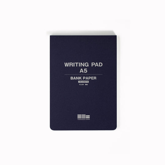 The pad is glue bound along the top edge for easy sheet removal, and the pad includes a removable guide sheet with grid layout on one side and ruled layout on the other.