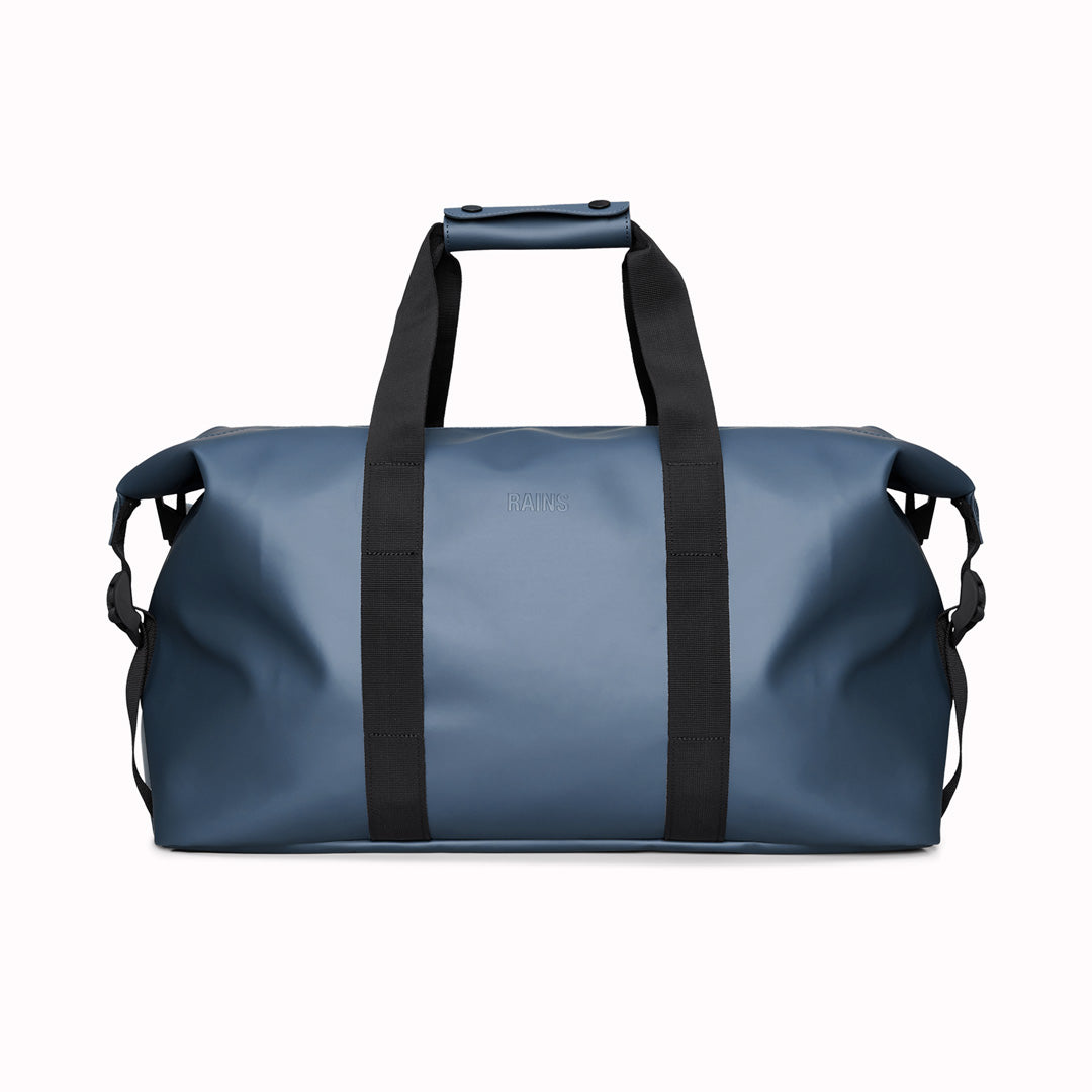 The Hilo Weekend Bag by Rains is a great contemporary gym or overnight bag. It features a single main compartment, carry handles, a detachable shoulder strap, and adjustable lock slider buckles on the sides.