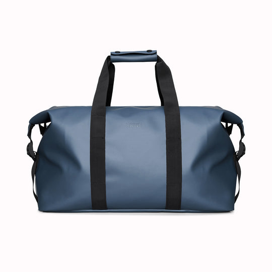 The Hilo Weekend Bag by Rains is a great contemporary gym or overnight bag. It features a single main compartment, carry handles, a detachable shoulder strap, and adjustable lock slider buckles on the sides.