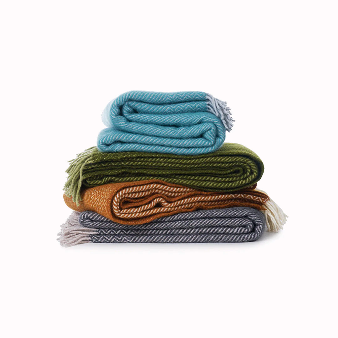 Bazaar Collection Stack - Bazaar is a premium and cosy Eco Lambswool throw in a rich cumin shade to suit neutral toned interiors. Perfect to snuggle up with on the sofa during the cold British Winter, or wrap it around yourself during cool evenings outdoors.