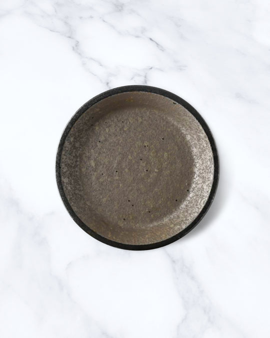 Rough textured serving plate with matt glaze in a dark brown shade that catches the light to reveal a silvery shimmer. Use for side dishes and snacks.