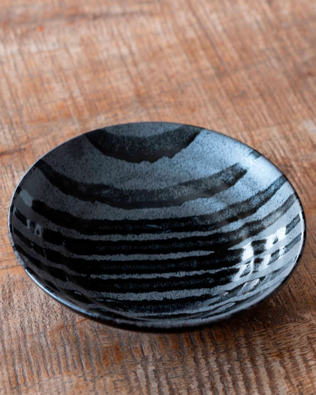 Matt black Shallow noodle bowl with irregular glossy glazed black stripes.