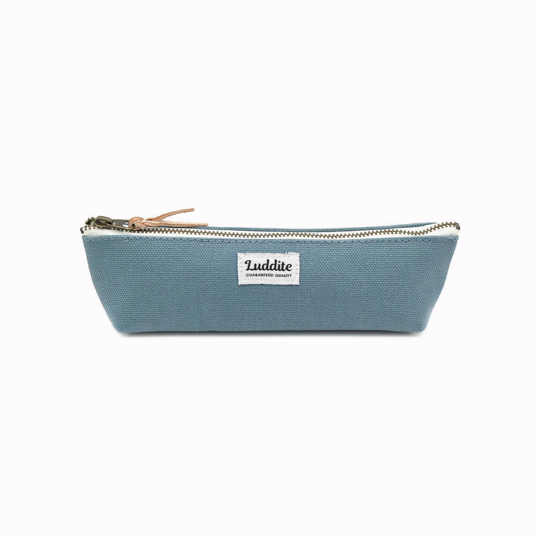 Boat shaped pen and pencil case by Japanese stationery brand Luddite.  The durable and tactile pencil case features a zipper along the length of the pencil case allows easy access to the items inside.