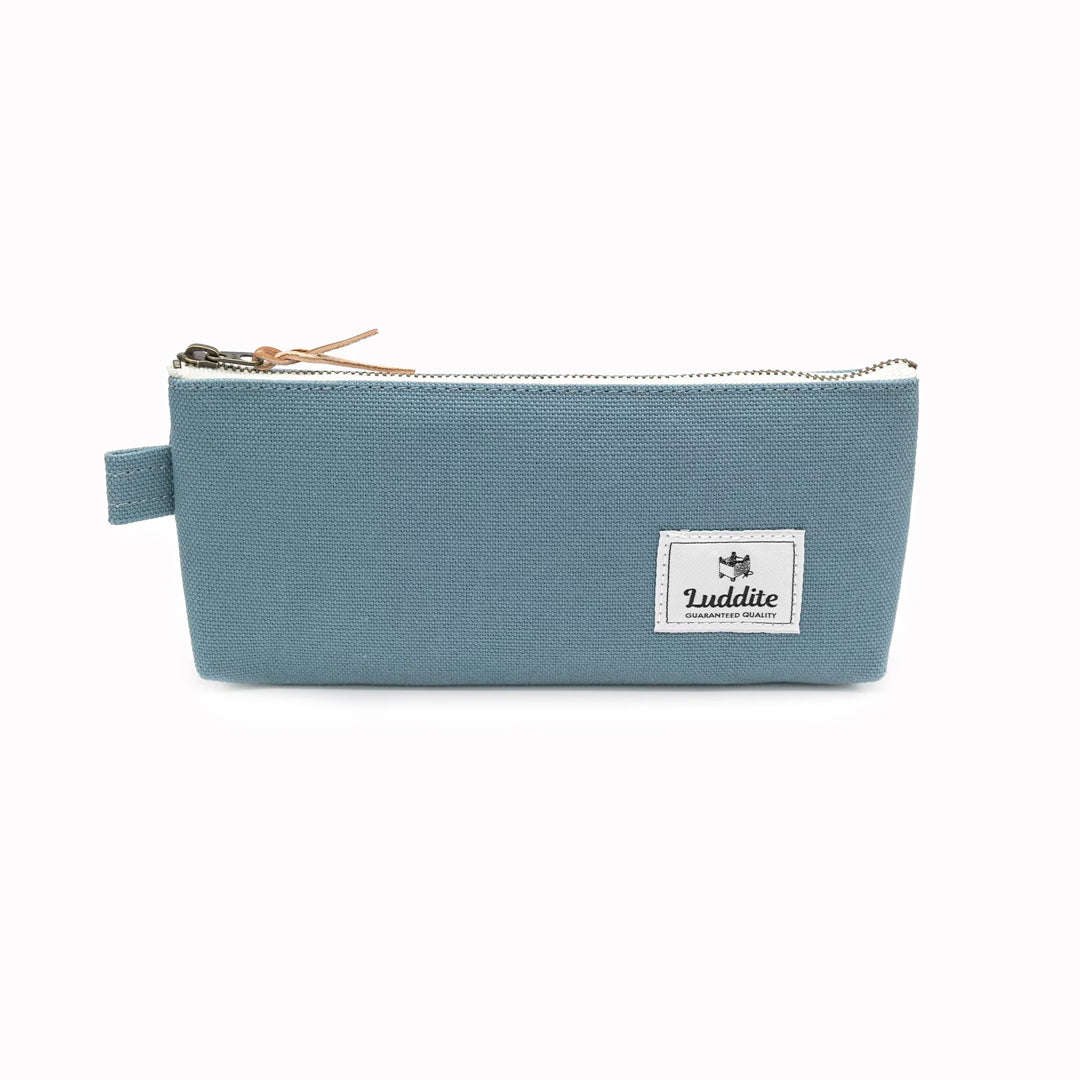 Flat pouch style pen and pencil case by Japanese stationery brand Luddite. the durable and tactile pencil case features a zipper along the length of the pencil case allows easy access to the items inside.