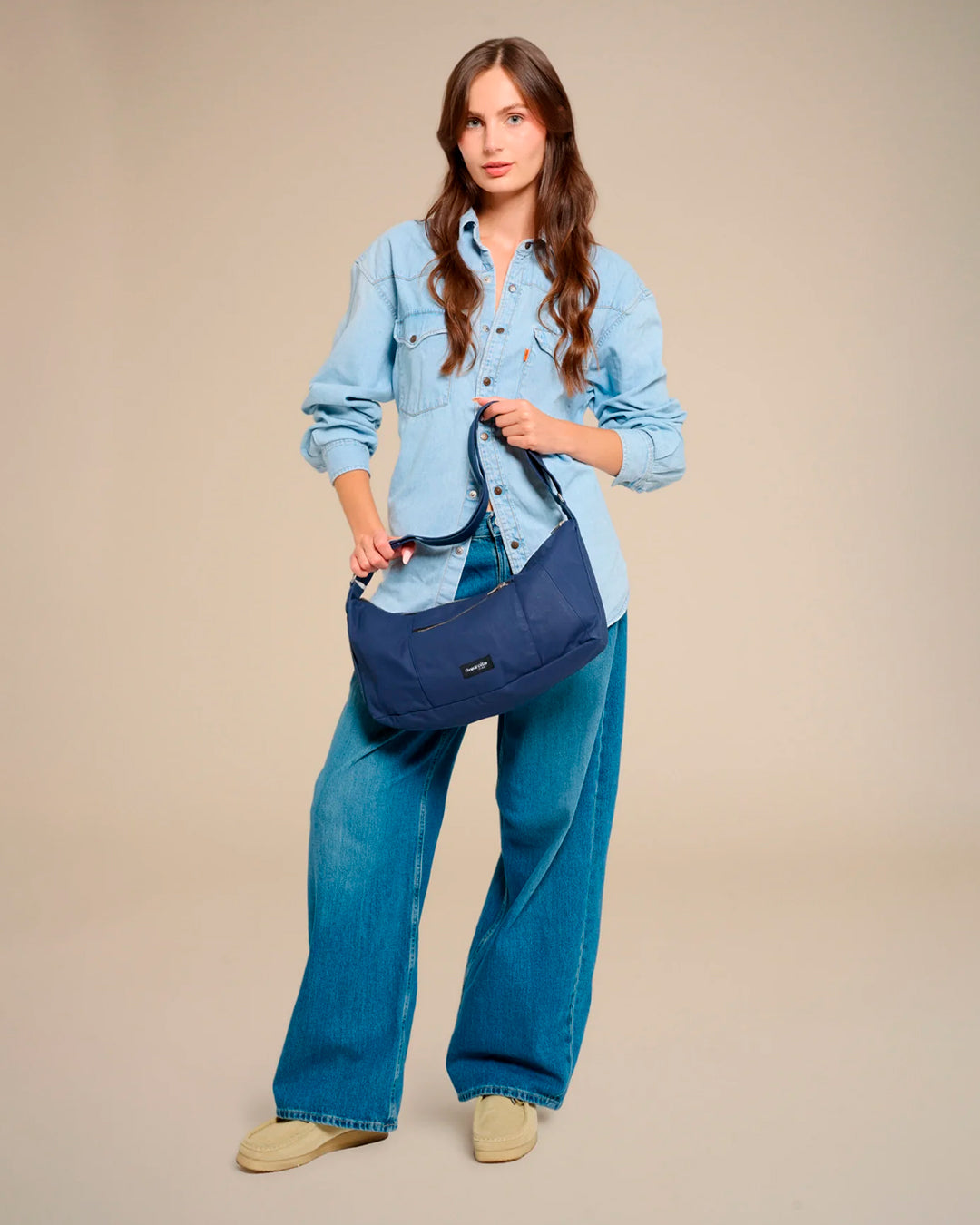 The Mini Charlot is a compact shoulder bag large enough for all your daily essentials. For AW26 the bag is made from a 100% organic cotton canvas fabric with a water resistant coating