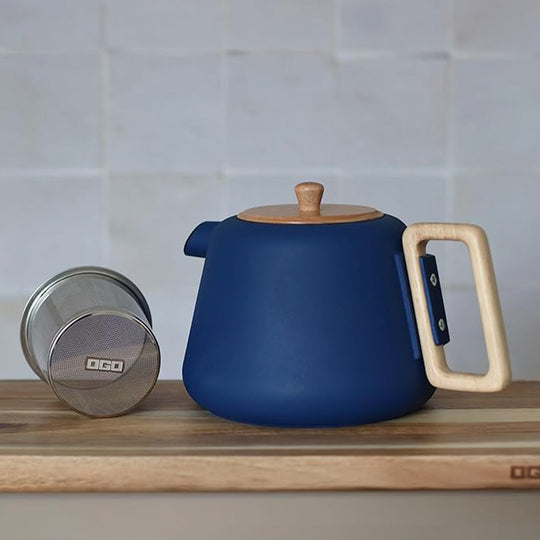 500ml cast iron tea pot with modern styling including almond green matte finish with a wooden handle and lid.