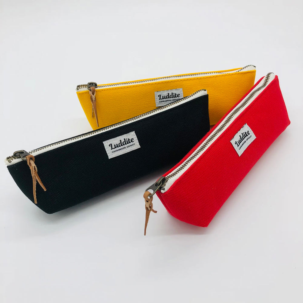 Boat shaped pen and pencil case by Japanese stationery brand Luddite.  The durable and tactile pencil case features a zipper along the length of the pencil case allows easy access to the items inside.