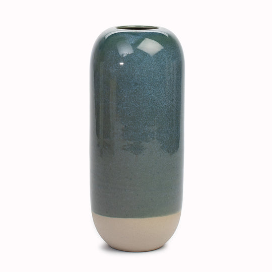 Studio Arhoj's Japanese inspired vases are named after the Japanese word for snow. The Bottomless Well design is hand-thrown in watertight stoneware. Due to the rounded taper at the top of the vase, the glaze melts down the sides of the cylindrical vase mimicking melting ice.