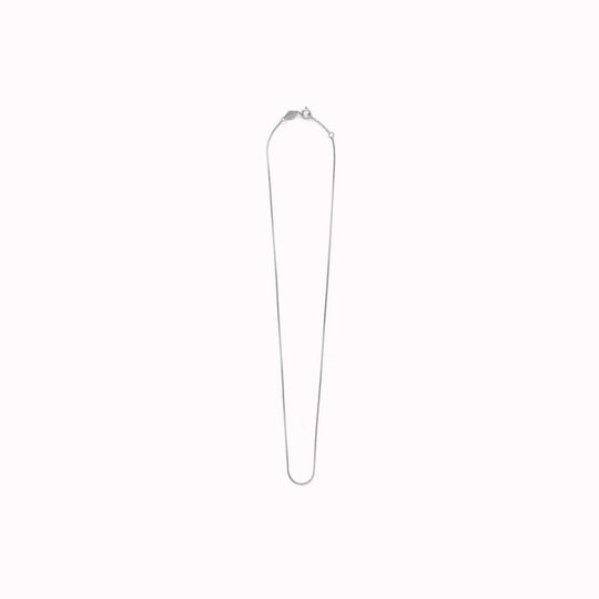 The Box Chain necklace from Anni Lu is a delicate chain necklace with a tight, square-link structure. 