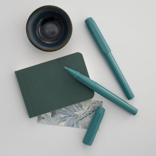 Lifestyle - The Kaweco Perkeo rollerball pen in Breezy Teal features an ergonomic grip, octagonal cap and hexadecagon shaped barrel.