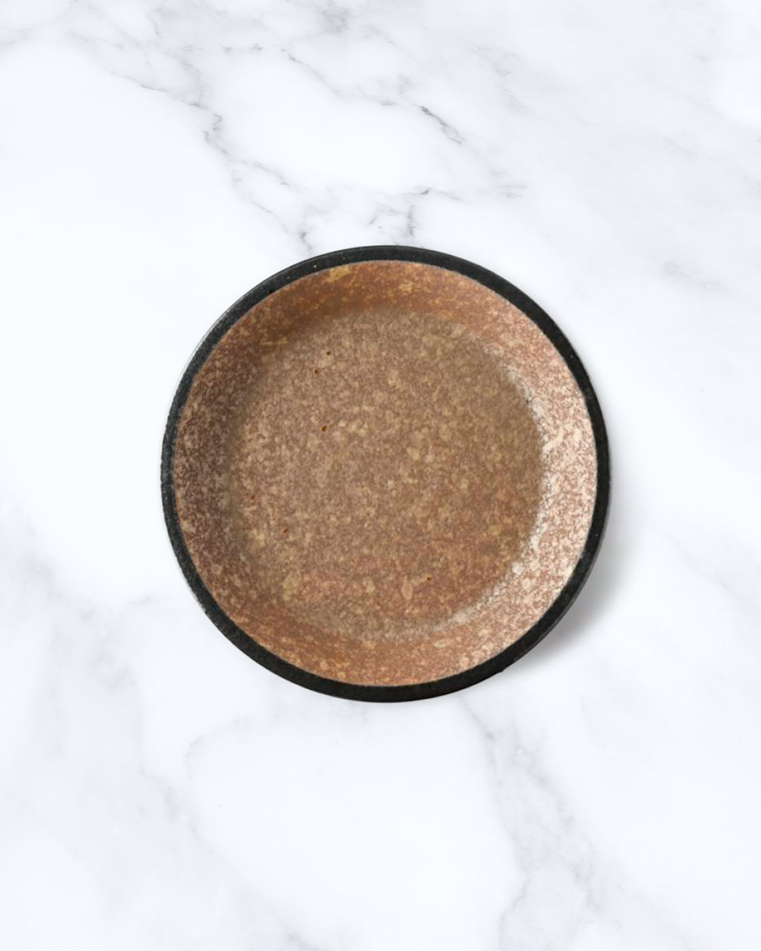 Rough textured plate with matt glaze in a coppery brown shade that catches the light to reveal a golden shimmer. Use to serve side dishes and snacks.