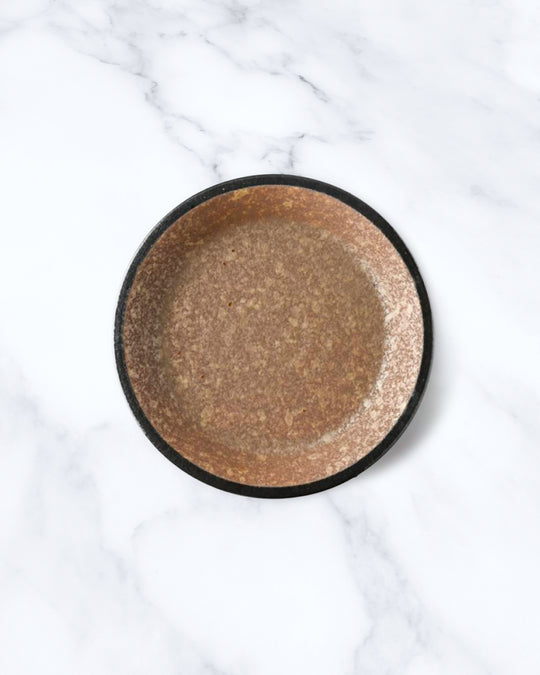 Rough textured plate with matt glaze in a coppery brown shade that catches the light to reveal a golden shimmer. Use to serve side dishes and snacks.