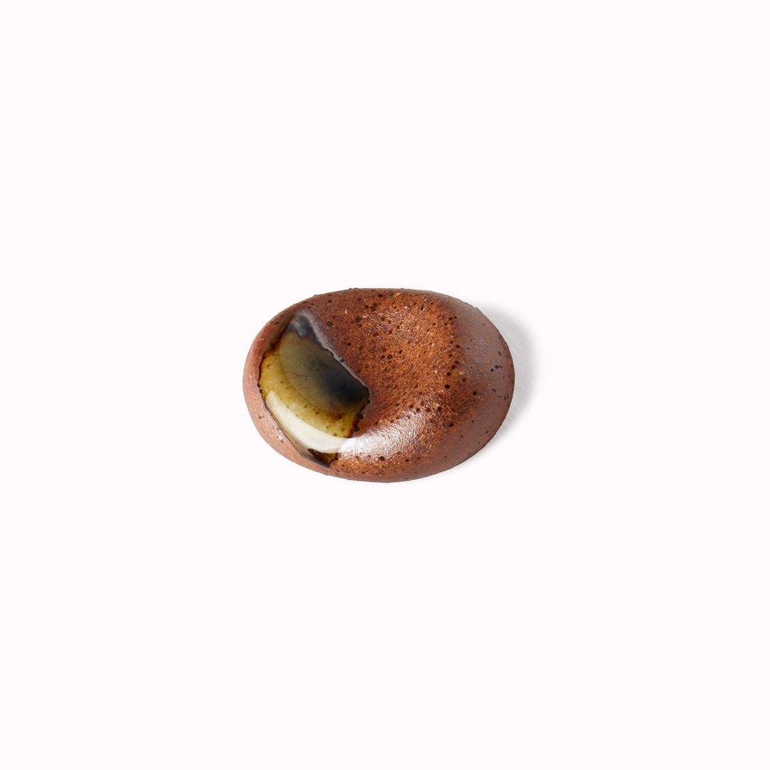 This ceramic pebble from MIJ makes a perfect chopstick rest, the majority of the pebble is a brown colour with lovely green splashes. 