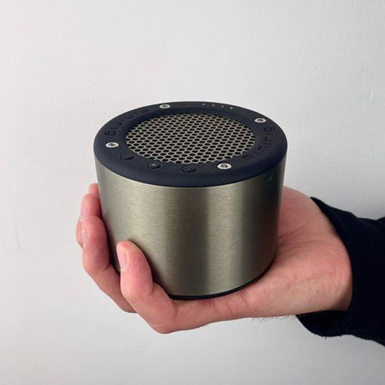 In Hand - The Minirig Mini 4 in Brushed Ion is a portable Bluetooth speaker that represents the latest innovation in audio technology. Crafted in Bristol, UK, this speaker is the result of over a decade of design evolution, offering a robust anodized aluminium and high-impact ABS construction.