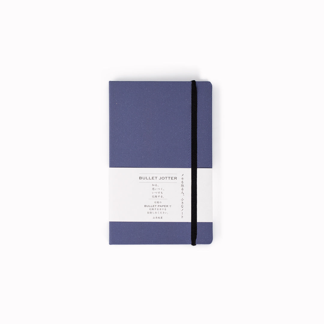 The Bullet Jotter by Yamamoto Paper is a modular note-taking system comprising an outer cover jacket with internal space to hold 2 bullet paper pads. 