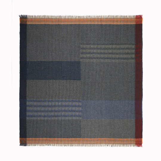 The Cairngorm Tweed Throw by Wallace and Sewell portrays the timeless beauty of Shetland wool craftsmanship. This particular throw features a harmonious blend of denim and rosemary green, set against the paler colours of the warp, creating a rich tapestry of structure and pattern.