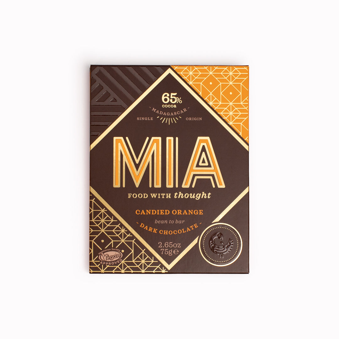 MIA's Candied Orange 65% dark single origin bean-to-bar chocolate contains the intensity of Madagascan 65% dark chocolate and is cut with a citrussy zing of infused orange throughout and chewy, candied orange pieces jewelled across its back.