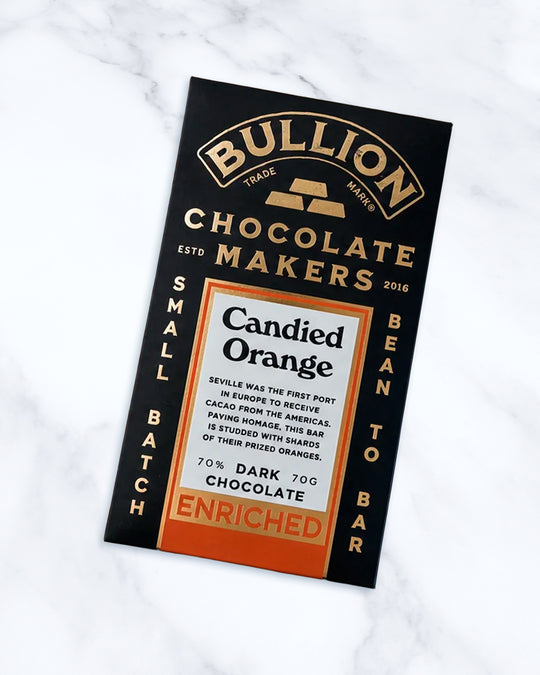 Seville was the first port in Europe to receive cacao from the Americas. Paying homage, this Bean-to-Bar dark chocolate bar from Bullion Chocolate is studded with shards of their prized oranges and infused with a delicious orange taste.