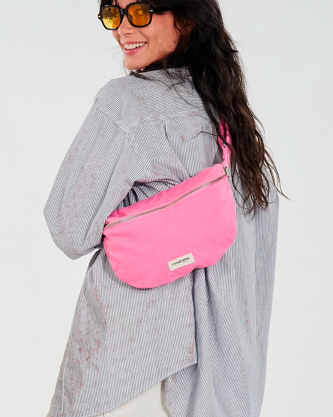 The Custine Belt Bag by Rive Droite Paris is a compact belt bag made from a Candy Pink recycled cotton fabric.