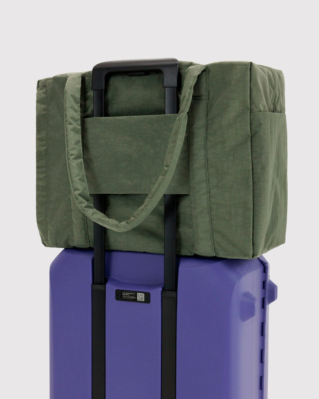 The BAGGU Cloud Carry-On is a spacious travel bag sized for overhead storage, with a trolley sleeve for easy attachment to your roller luggage. 