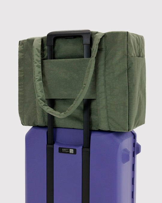 The BAGGU Cloud Carry-On is a spacious travel bag sized for overhead storage, with a trolley sleeve for easy attachment to your roller luggage. 