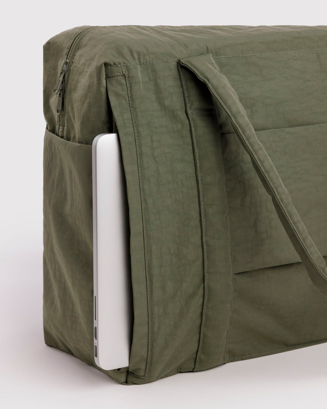 The BAGGU Cloud Carry-On is a spacious travel bag sized for overhead storage, with a trolley sleeve for easy attachment to your roller luggage. 