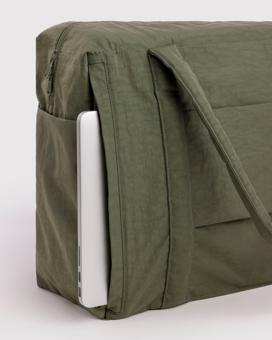 The BAGGU Cloud Carry-On is a spacious travel bag sized for overhead storage, with a trolley sleeve for easy attachment to your roller luggage. 