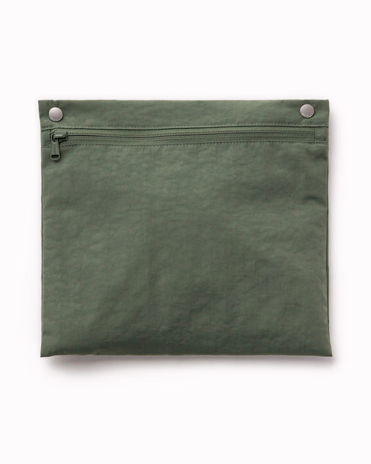 The BAGGU Cloud Carry-On is a spacious travel bag sized for overhead storage, with a trolley sleeve for easy attachment to your roller luggage. 