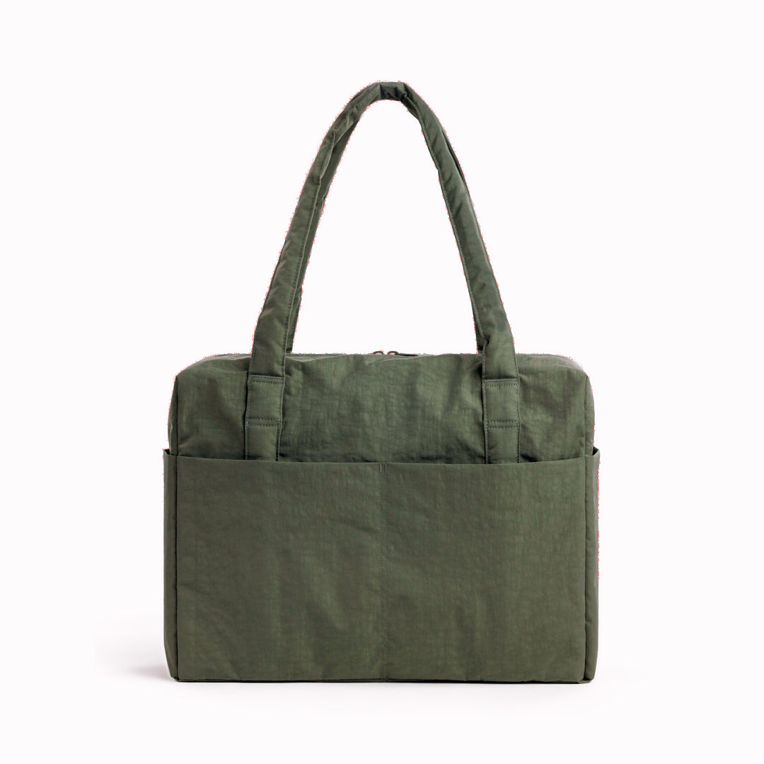 The BAGGU Cloud Carry-On is a spacious travel bag sized for overhead storage, with a trolley sleeve for easy attachment to your roller luggage. 