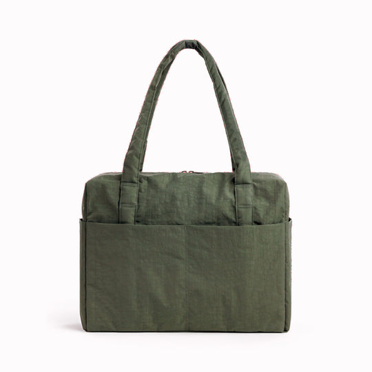 The BAGGU Cloud Carry-On is a spacious travel bag sized for overhead storage, with a trolley sleeve for easy attachment to your roller luggage. 