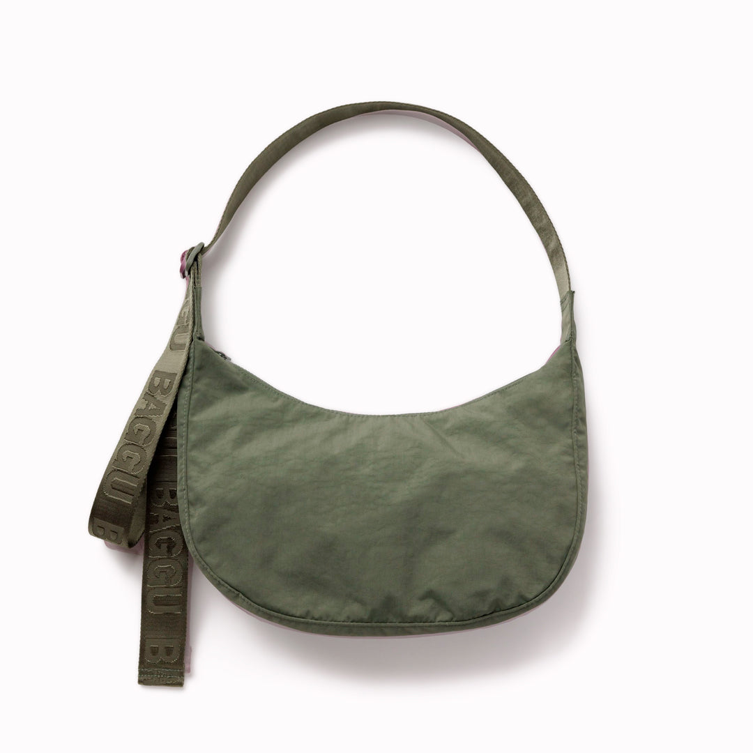 Made from recycled heavyweight nylon with a ripstop lining, it holds its form while staying lightweight. The strap adjusts to wear crossbody or over the shoulder, shifting the silhouette depending on how it’s carried.