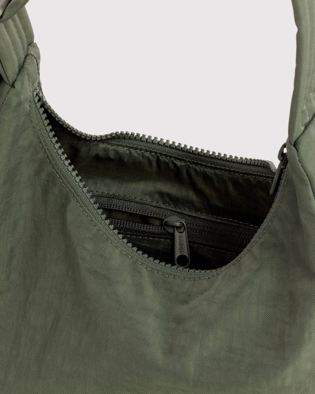 A compact version of BAGGU's signature shoulder bag, finished in a muted Caper colourway. The softly structured shape sits neatly under the arm