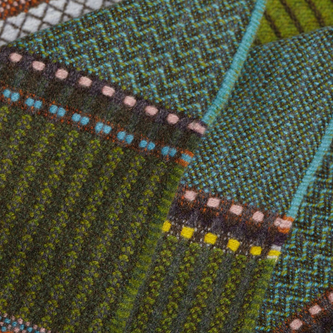 The Cassia lambswool Scarf by Wallace and Sewell showcases the intricate craft of textile design, blending traditional techniques with modern aesthetics.