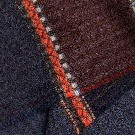 The Cassia lambswool Scarf by Wallace and Sewell showcases the intricate craft of textile design, blending traditional techniques with modern aesthetics.