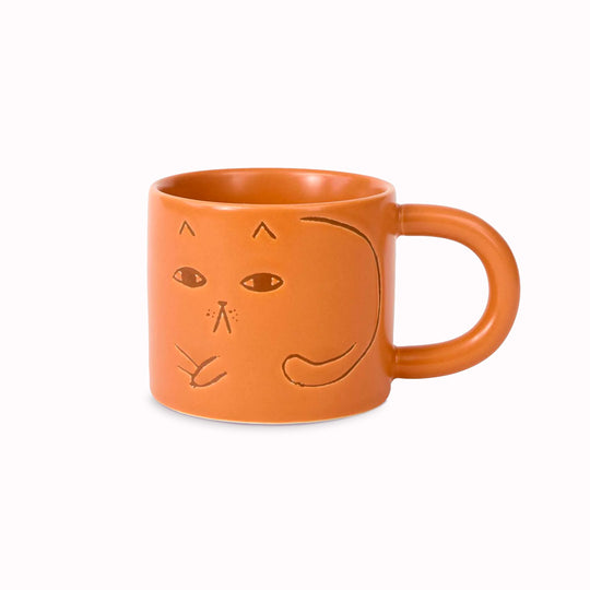 Cat mug on a ginger glazed stoneware base. Features a debossed cat image on 2 sides.