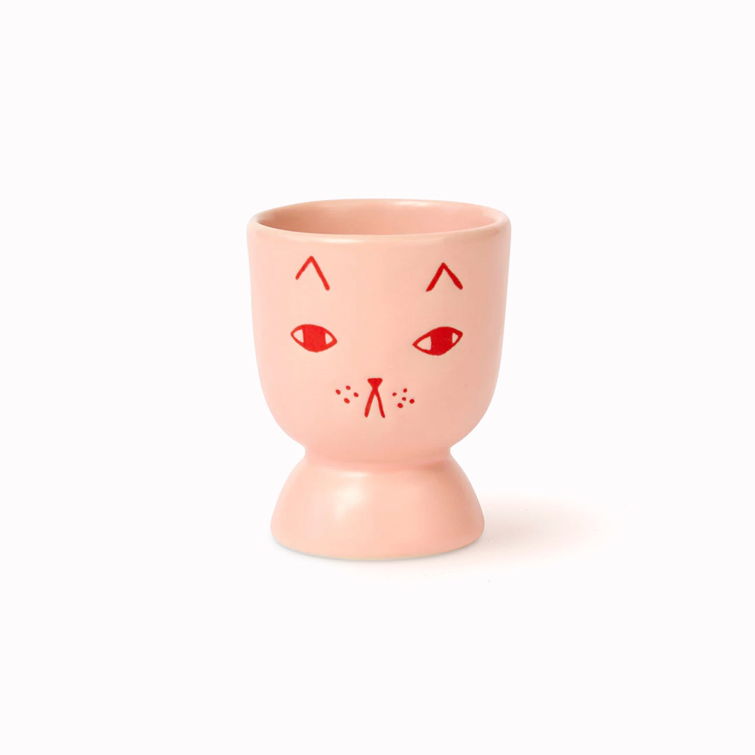 Donna Wilson Stoneware Egg Cup in candy pink stoneware featuring a cute (if grumpy) cat illustration